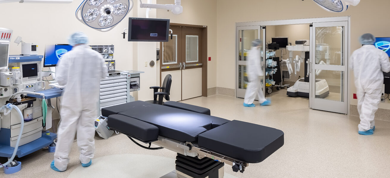Surgeons work inside the robotic OR in the MMC Ashland Surgery Center. A surgery robot is stored inside a small