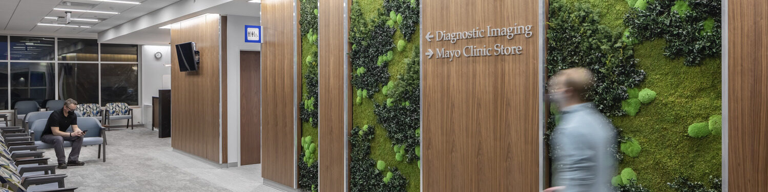 People wait in the Mayo Clinic Health System in Mankato imaging lobby with a green wall.