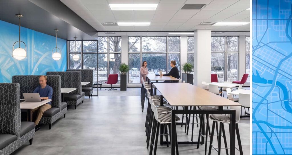 An open work cafe with flexible seating options and views to nature.