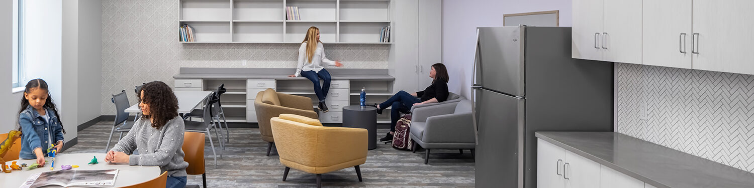 People sitting and eating in the PRIDE program kitchen.