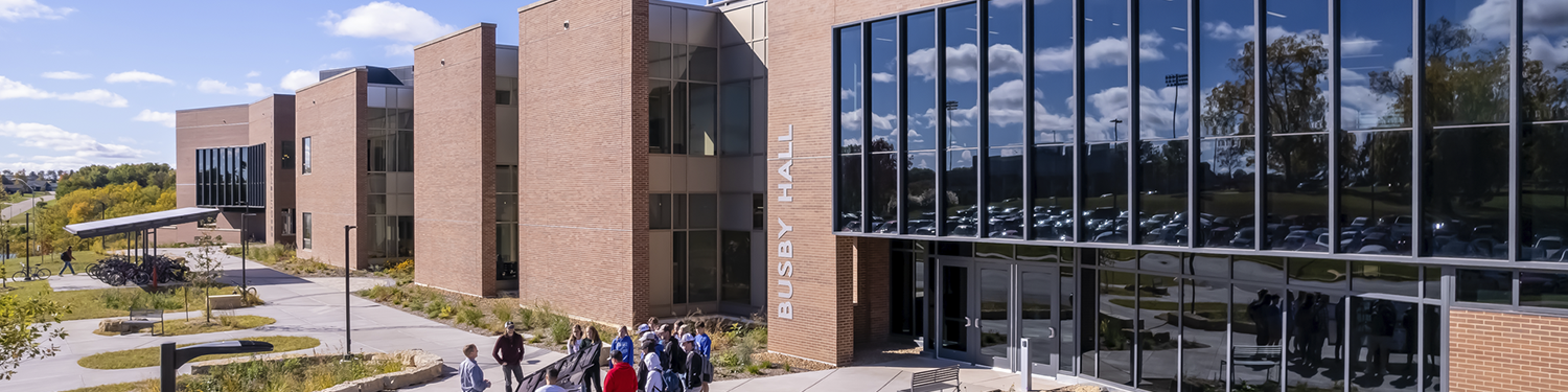 Students attend a class to learn about solar power at the Sesquicentennial Hall entry.
